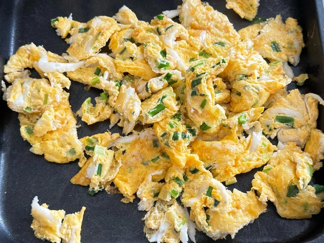 Close-up of Scrambled Eggs with Silverfish in Office Electric Pancake Pan